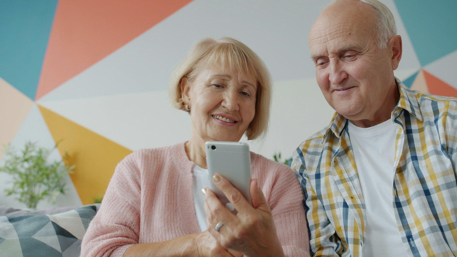 Couple in their seventies looking at a phone together