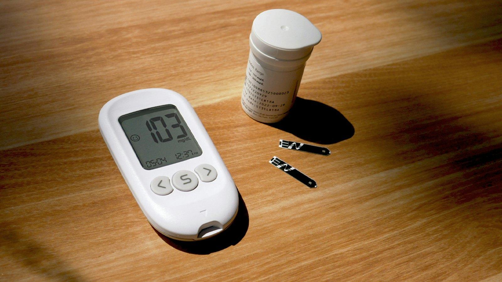 Blood glucose meter and test strips on a table