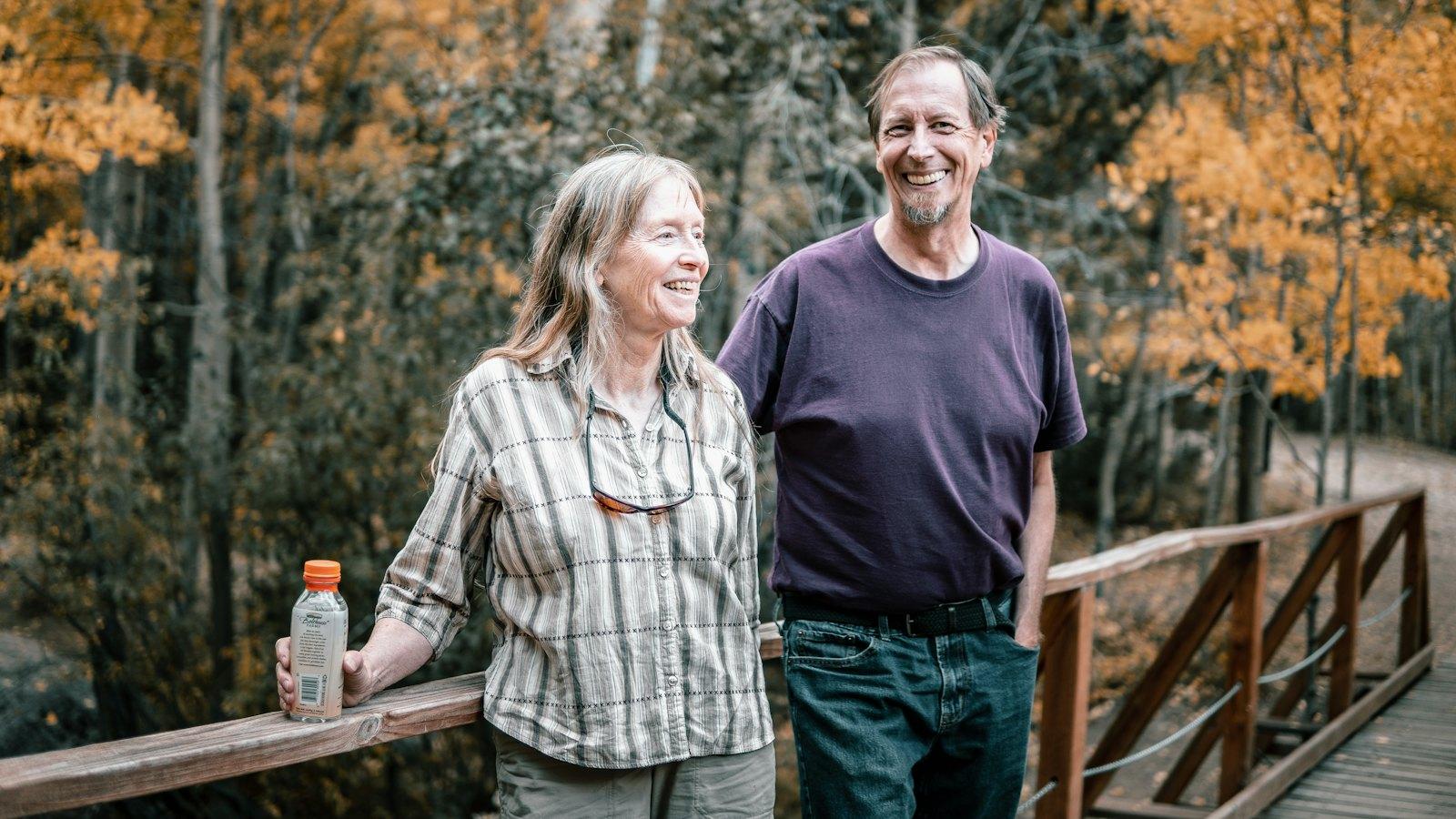 Couple in their fifties walking on an autumn trail