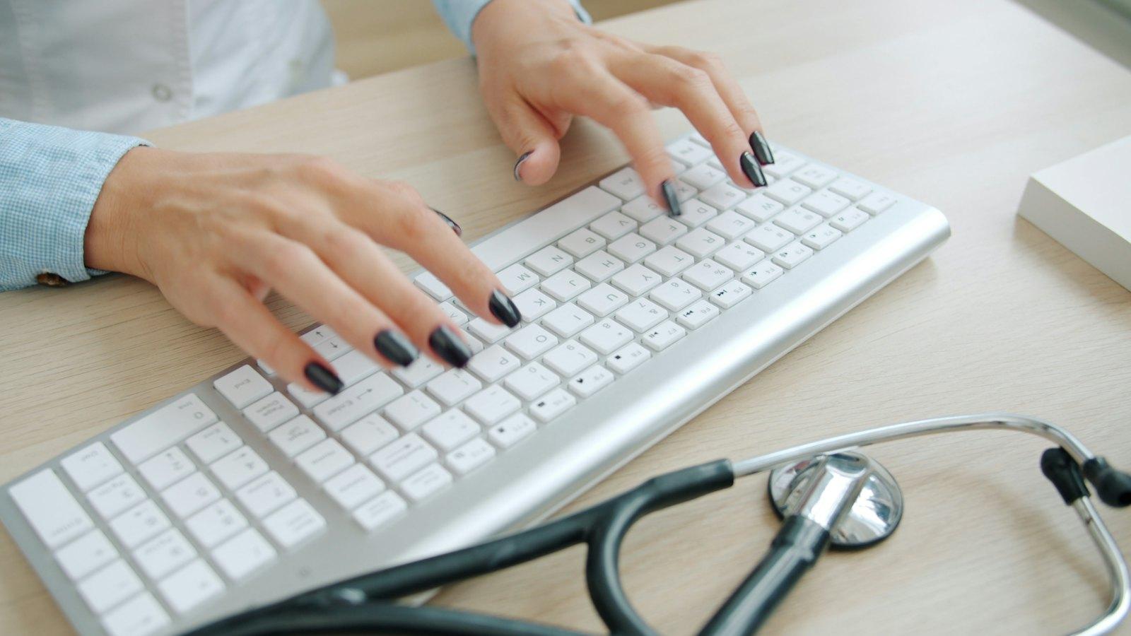 Stethoscope beside a keyboard on a desk