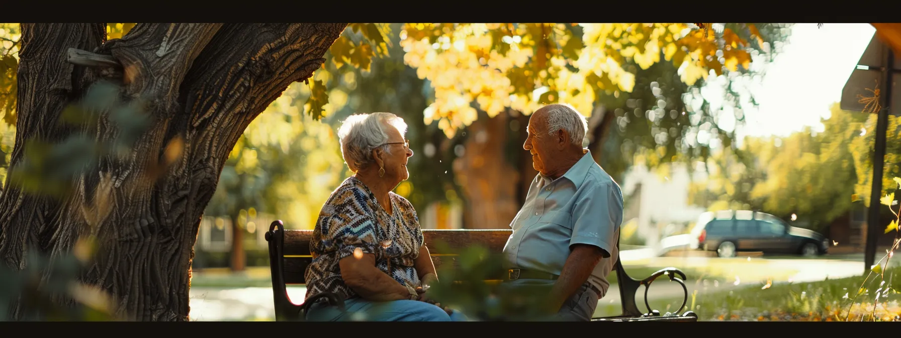 a somber elderly couple receiving a prompt payout from a final expense insurance policy under a peaceful tree.