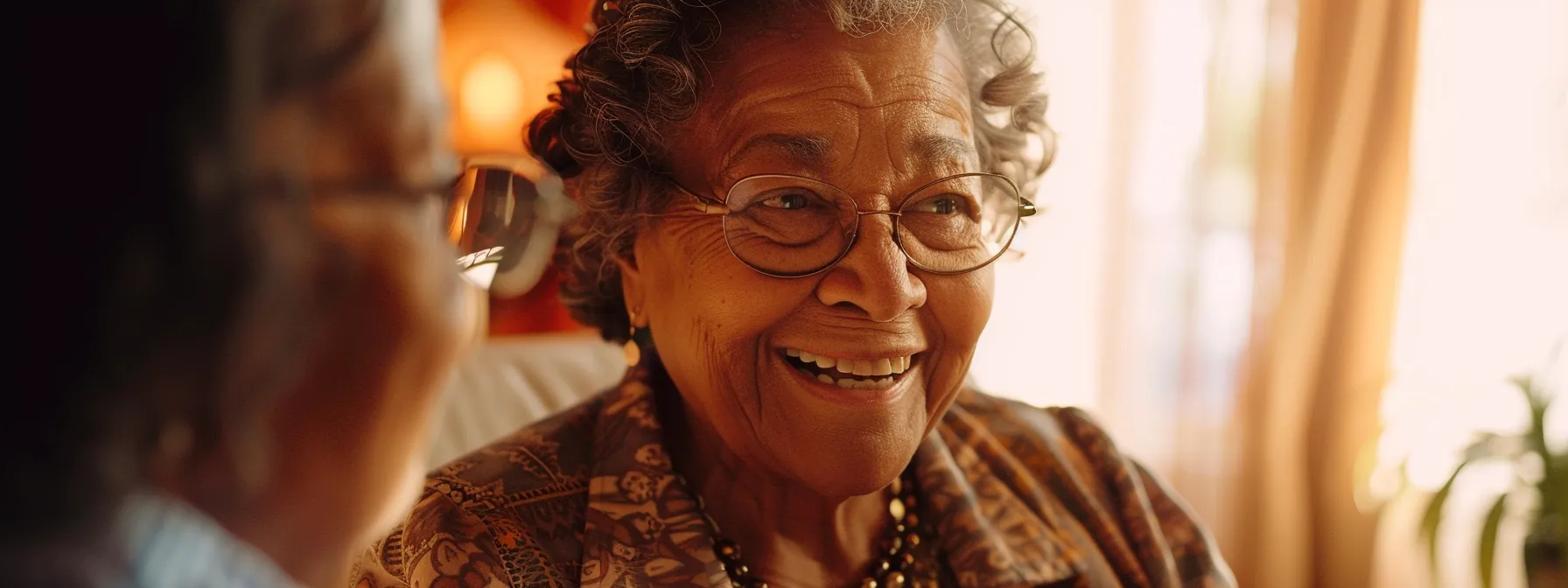 a senior citizen smiling brightly as they receive financial assistance paperwork from a helpful advisor.