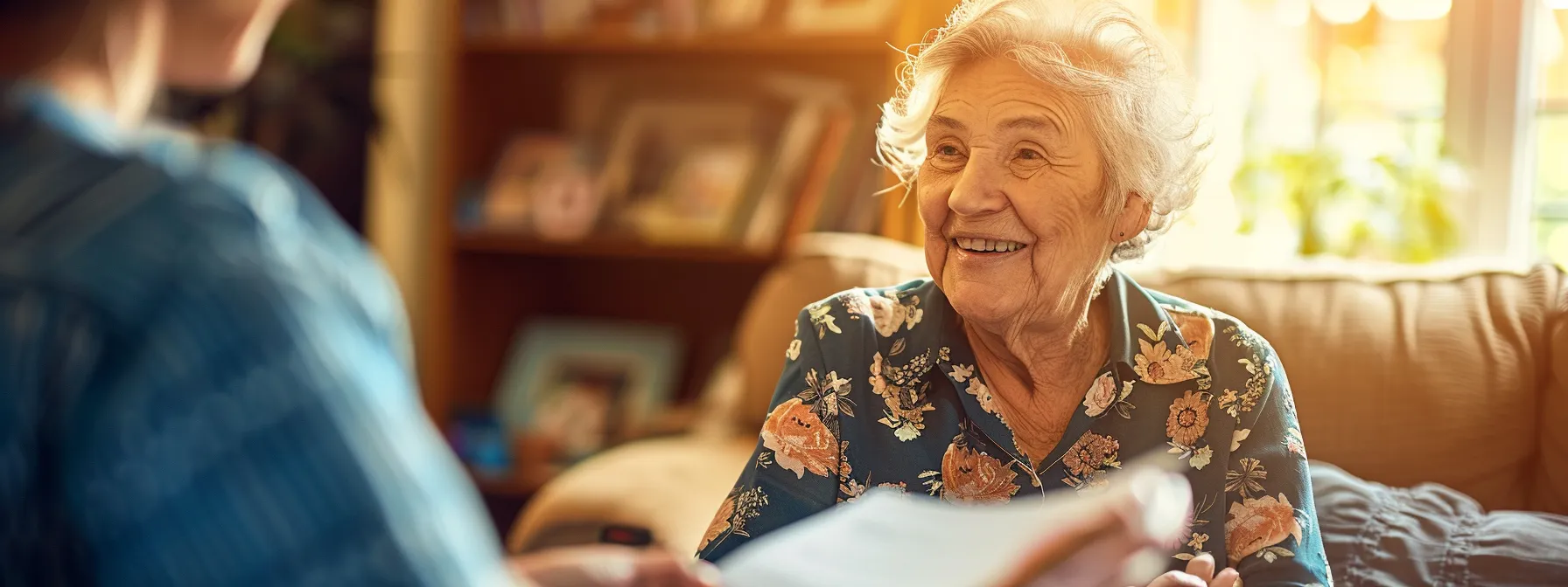 a tranquil elderly couple smiling while holding hands and discussing final expense insurance options, surrounded by a stack of informative brochures on a sunny afternoon in a cozy living room.