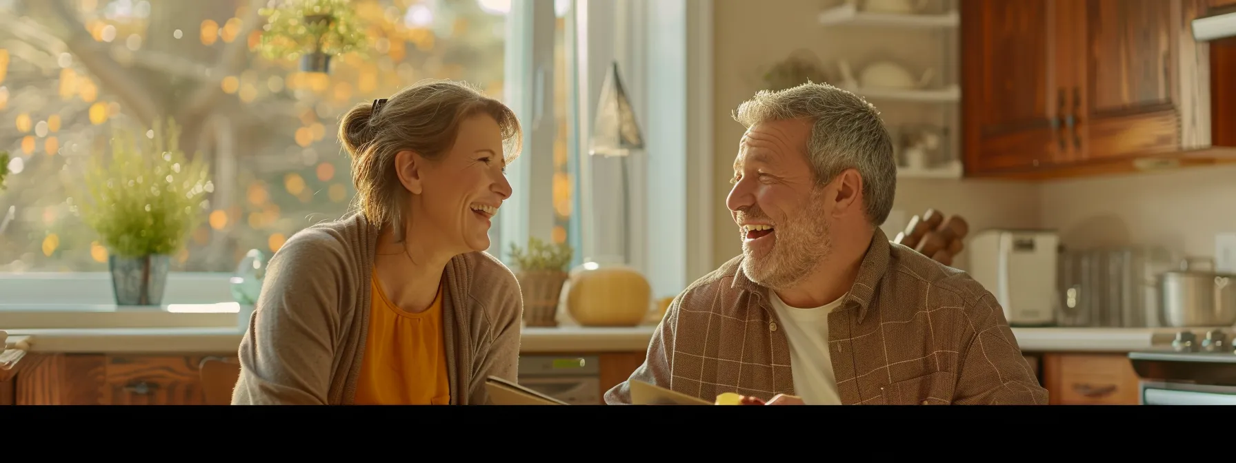 a middle-aged couple smiling as they review final expense insurance policy options together at a cozy kitchen table.