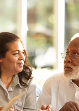 a diverse group of individuals of different ages and backgrounds discussing whole life insurance options in a modern, brightly lit office space.