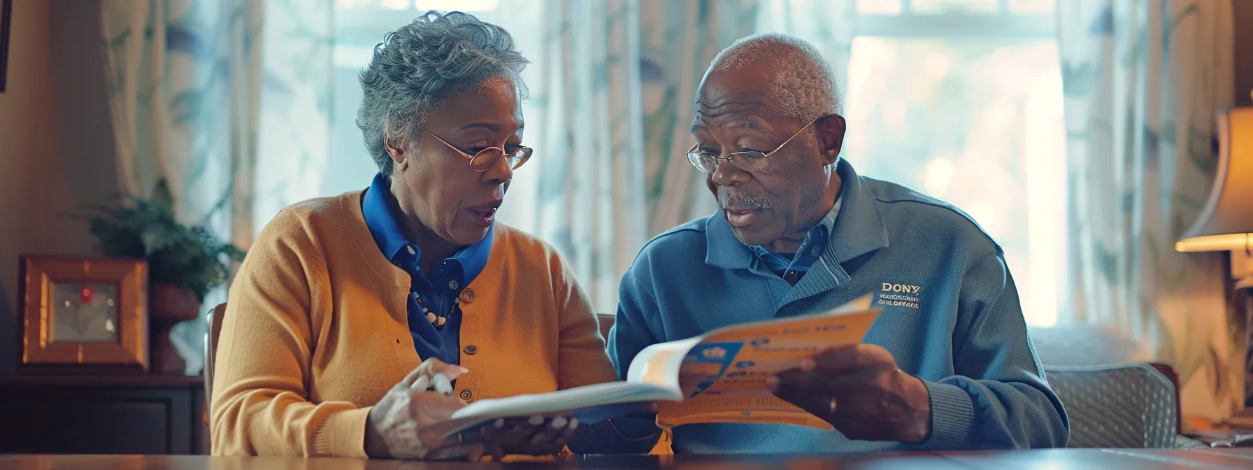 a senior couple reviewing medicare advantage and medigap brochures at a table, discussing enhanced healthcare coverage options.